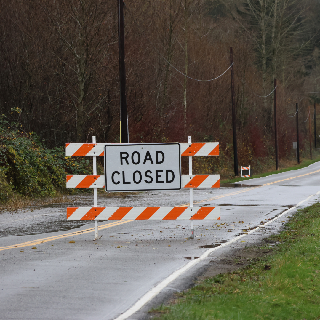 Road closure sign with water over roadway on 152nd St NE, Marysville WA 