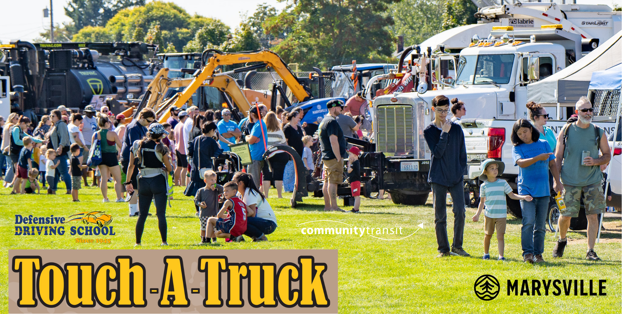 Participants exploring vehicles from a past Touch A Truck event at Asbery Field