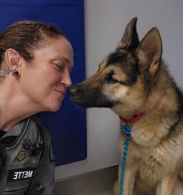 Community Service officer kissing dog